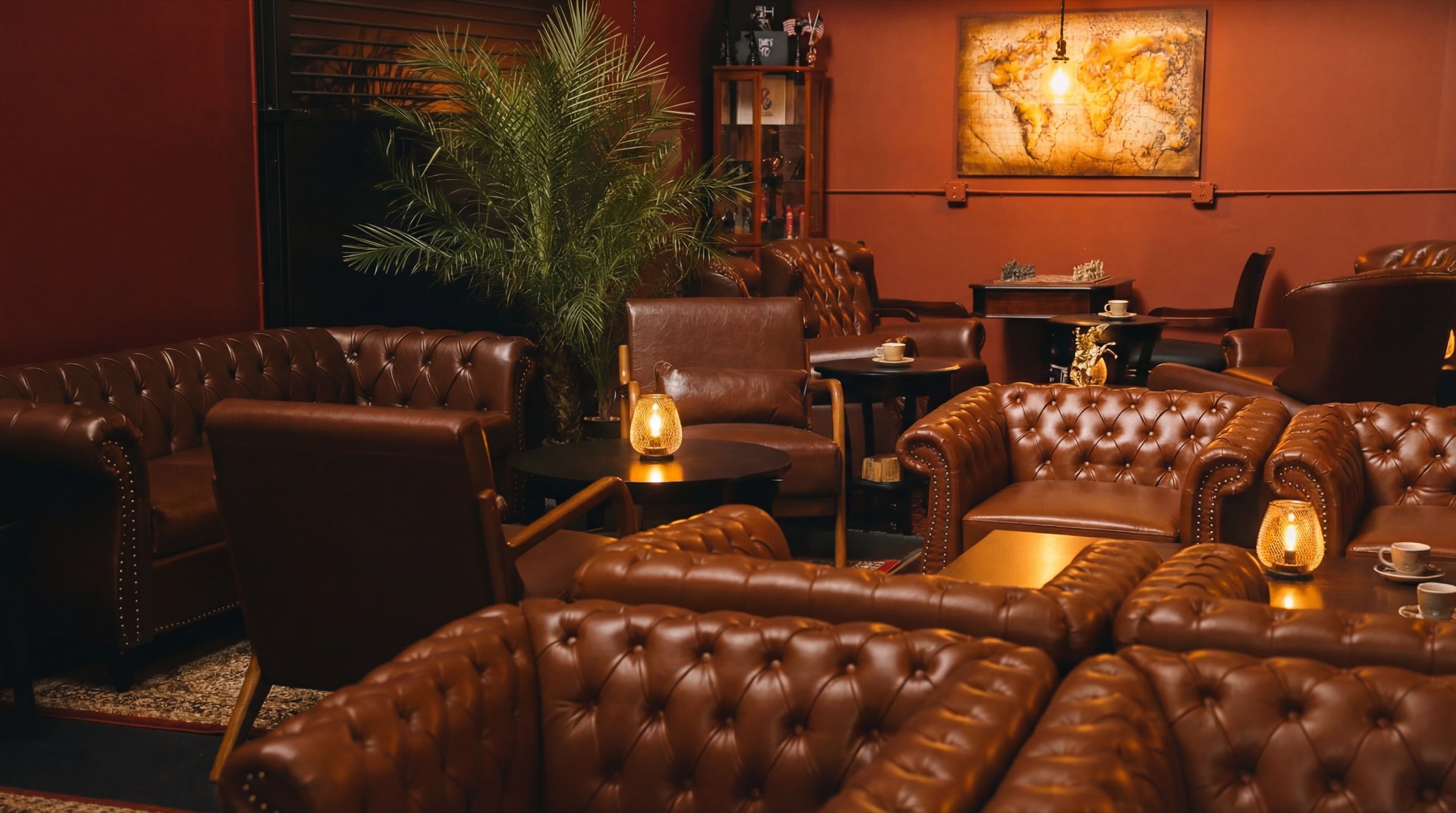 Wide view of Cuban Social Club lounge with warm lighting, vintage decor, and comfortable seating
